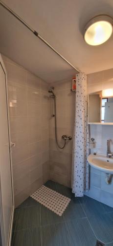 a bathroom with a shower and a sink at Bungalow GHP-B in Varna City