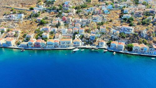 an aerial view of a group of houses and the water at Pitini Sevasti house in Symi