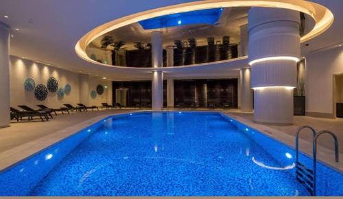 a large swimming pool in a building with a ceiling at High Residence -Monthly rental- Mall of Istanbul in Istanbul