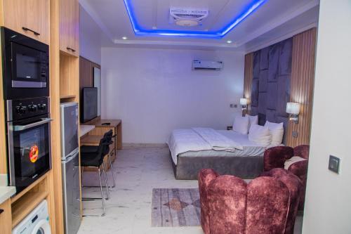 a hotel room with a bed and a tv at Roof top Studio+Gym+Snooker Rhodabode Apt, Nile in Abuja