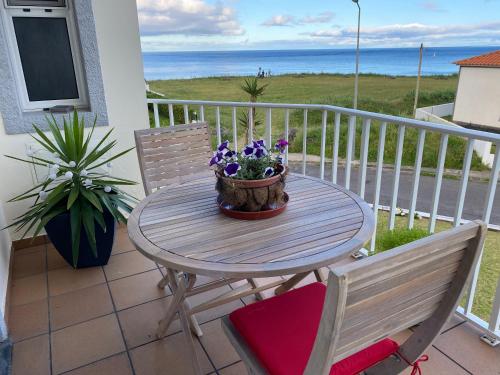 a table and two chairs on a balcony with the ocean at Mountain and Ocean View in Água de Alto
