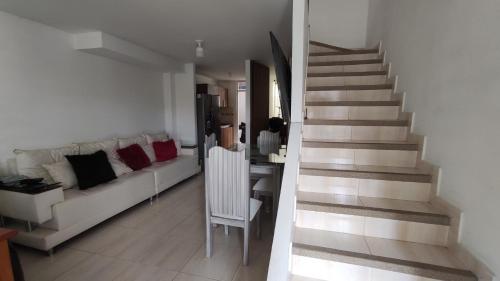 a living room with a couch and a staircase at Habitación en casa in Pereira