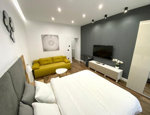 a living room with a couch and a tv at MONI Downtown Luxury Apartments in Belgrade
