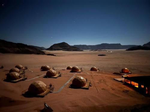 a group of domes sitting in the desert at Hasan Zawaideh luxury camp 2 in Wadi Rum