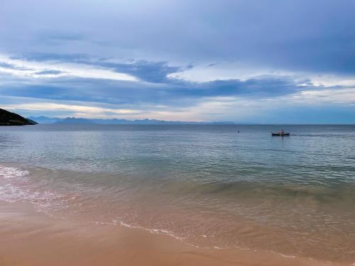 a boat in the water on a beach at Villa Balthazar in Búzios