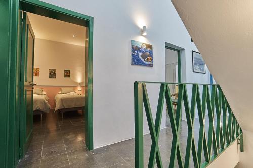 a hallway with a green door leading to a bedroom at Malibú Mogán Casa Vintage - Amazing sea/harbour view in Puerto de Mogán