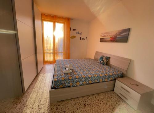a small bedroom with a bed with a teddy bear on it at Appartamento Ponente in Balestrate