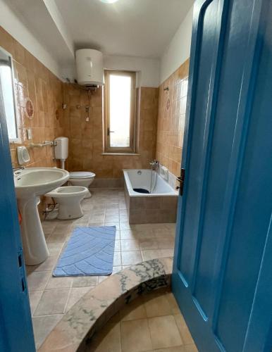 a bathroom with a tub and a toilet and a sink at Appartamento Ponente in Balestrate