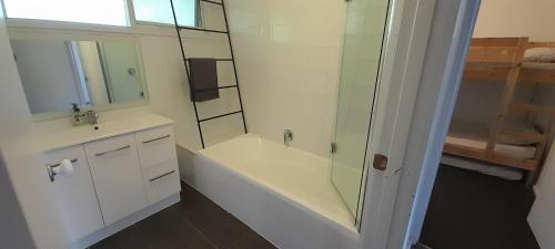 a bathroom with a tub and a sink and a shower at Beauna Vista Rye Holiday Home in Rye