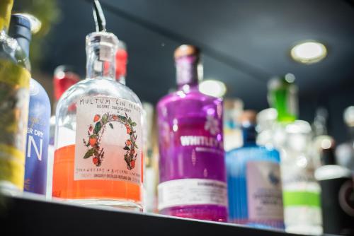 a group of bottles of alcohol sitting on a shelf at The Crown in Uppingham