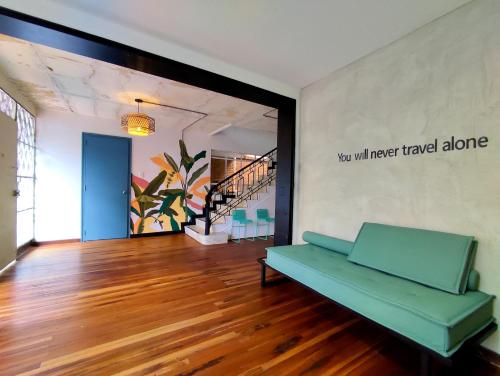 a living room with a green couch on a hard wood floor at Trip Monkey Chapinero in Bogotá