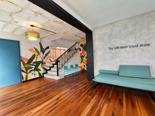 a room with a staircase and a mural on the wall at Trip Monkey Chapinero in Bogotá