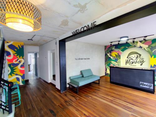 a room with a couch and a sign on the wall at Trip Monkey Chapinero in Bogotá