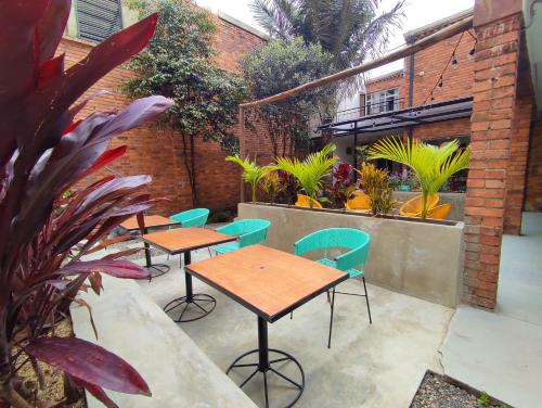 a patio with tables and chairs and plants at Trip Monkey Chapinero in Bogotá
