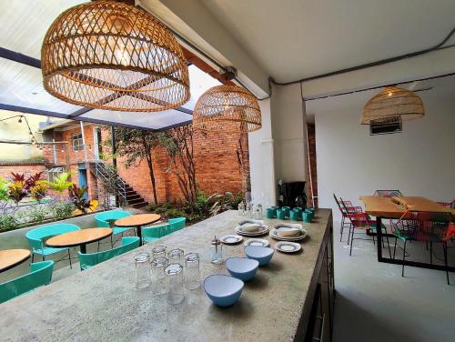 a restaurant with a table with plates and glasses on it at Trip Monkey Chapinero in Bogotá