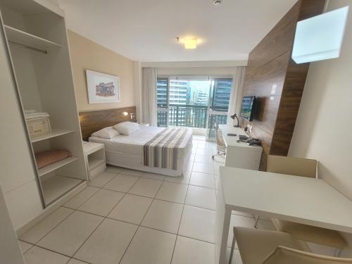 a hotel room with a bed and a balcony at Vision Executive, Brasília in Brasília