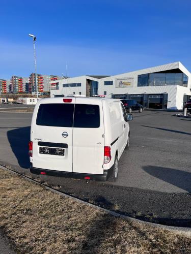 a white van is parked in a parking lot at Cheap Camper Van in Iceland in Reykjavík