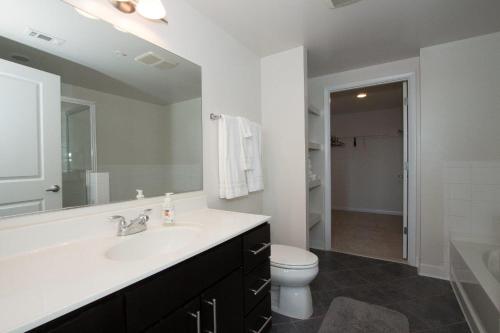 a bathroom with a sink and a toilet at Nice 2BR Pentagon City Apartment in Arlington