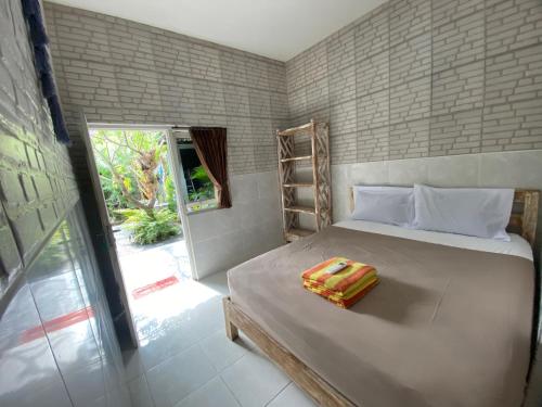 Kama o mga kama sa kuwarto sa Guest House Home 46 Bali