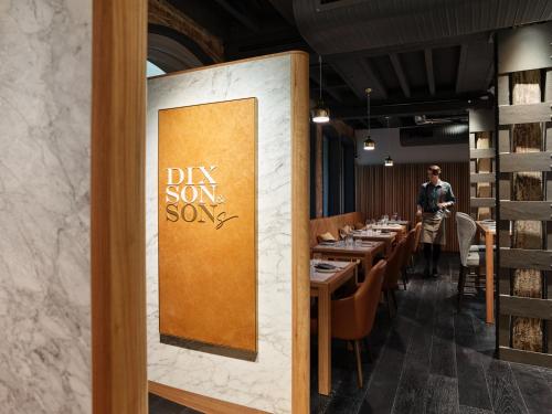 a dining room with a sign that reads dry son song at The Porter House Hotel Sydney - MGallery in Sydney
