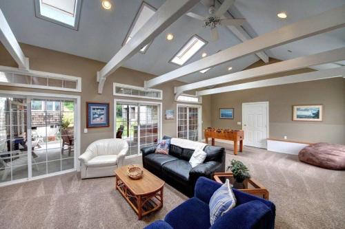 a living room with a couch and a table at SEASIDE MANOR-THE HEART OF SEASIDE in Seaside