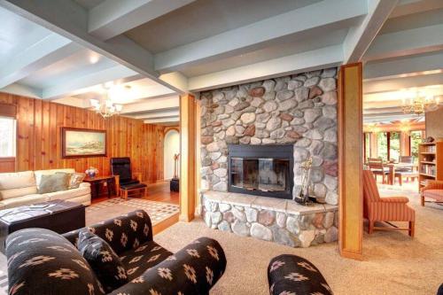 a large living room with a stone fireplace at SEASIDE MANOR-THE HEART OF SEASIDE in Seaside