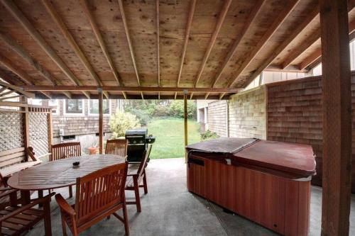 a patio with a grill and a table and chairs at SEASIDE MANOR-THE HEART OF SEASIDE in Seaside