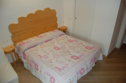 a bedroom with a bed with a wooden headboard at Agriturismo Prato degli Angeli in Sassoleone
