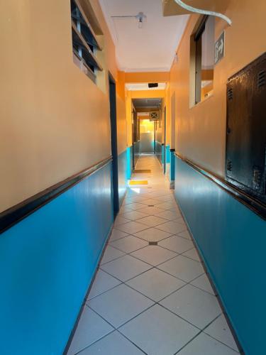 a corridor of a hospital hallway with blue lights at Pousada Ferreira III in Aracaju