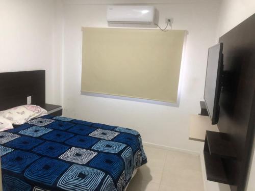 a bedroom with a bed and a projector screen at punto de encuentro in Corrientes