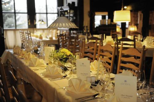 a long table with white table cloth and flowers on it at Hof Hueck in Bad Sassendorf
