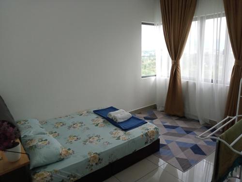 a bedroom with a bed and a window at FZ Almyra Homestay in Kajang
