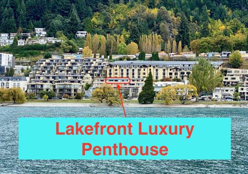 a view of a lakefront luxury peninsula with a sign at Lakefront Luxury Penthouse central Queenstown in Queenstown