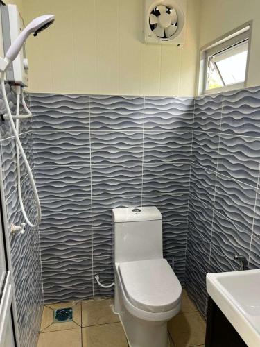 a bathroom with a toilet and a sink at Laman Cottage @ Brisu, Melaka in Malacca