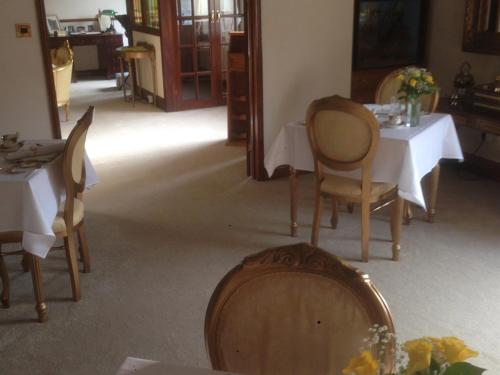 a dining room with a table and chairs and a table and chairsktop at Melody House in Fakenham