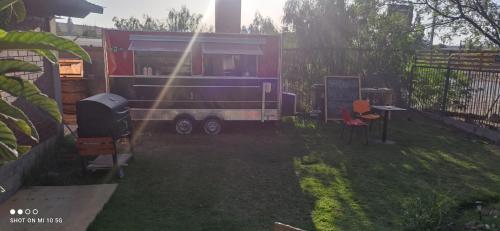 a rv parked in a yard with a grill at Las Cabañas del Francés in Vallenar