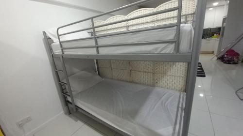 a metal shelf in a room with white walls at CUSHY DORM at KLCC in Kuala Lumpur