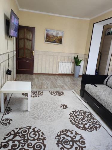 a living room with a couch and a table at Квартира 5-9 in Aktau