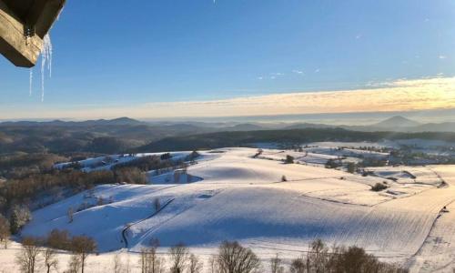 a snow covered hill with a town in the distance at Ferienwohnung Jurga in Pirna