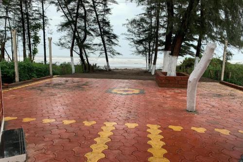 a red brick ground with yellow stars on it at Suma beach resort in Dapoli