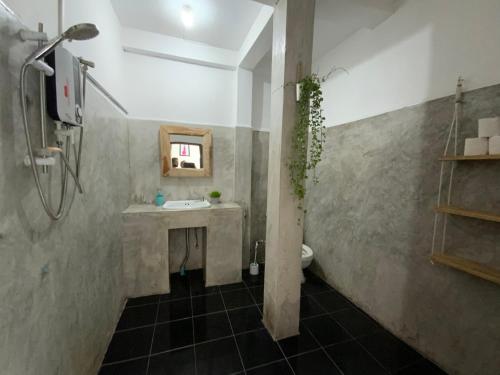 a bathroom with a shower and a sink and a toilet at La Casa - Thakhek in Thakhek
