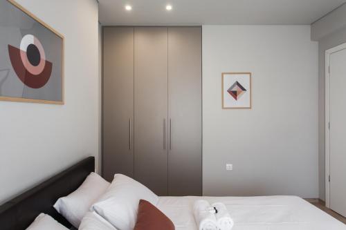a bedroom with a bed and a closet at Porto Pireo in Piraeus