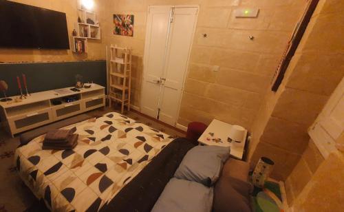a small bedroom with a bed and a couch at Seven in Sliema