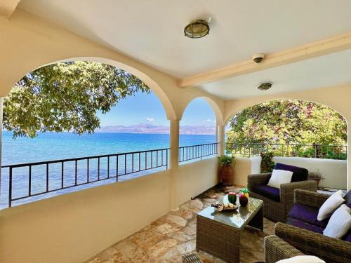 a living room with a view of the ocean at Apraos Beachfront House by DadoVillas in Apraos
