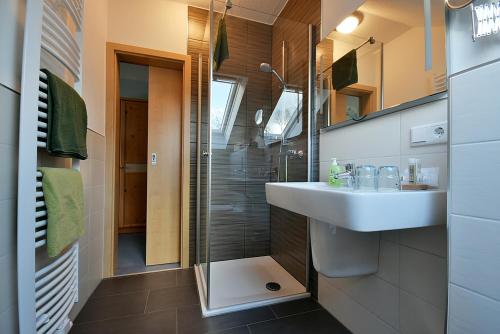 a bathroom with a sink and a shower at Pension Ederstrand in Frankenberg