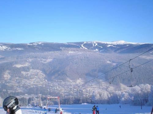 a group of people on a ski lift in the snow at Apartment Ulrich in Jablonec nad Jizerou