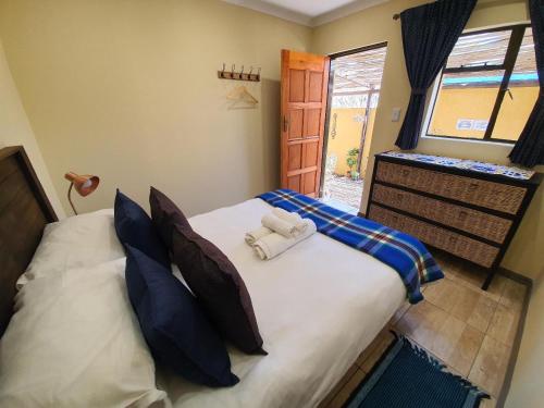 a bedroom with a bed with two towels on it at Lebo's Soweto Backpackers in Soweto