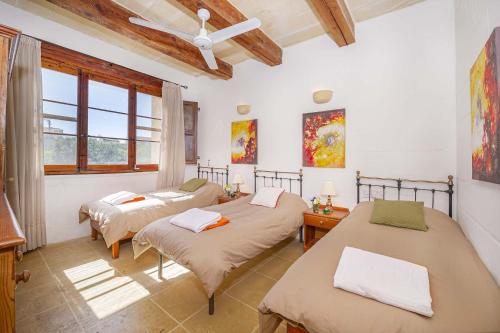 a bedroom with two beds and a window at Razzett Luna Holiday Home in Xagħra