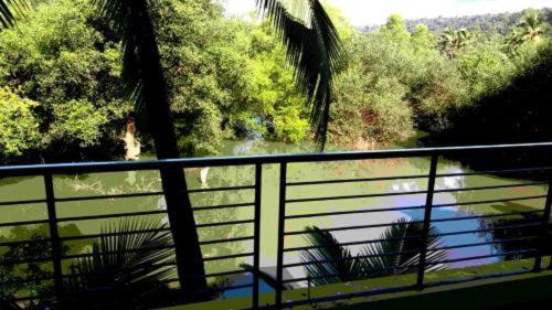 a balcony with two chairs and a view of a river at SAHAY VILLA RESORT in Durbate