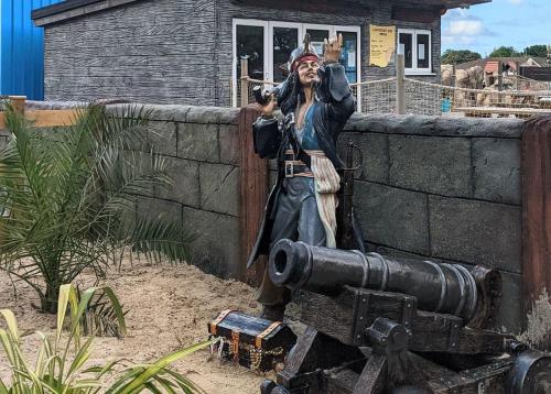 a statue of a man standing next to a cannon at Monkey Tree Holiday Park in Newquay